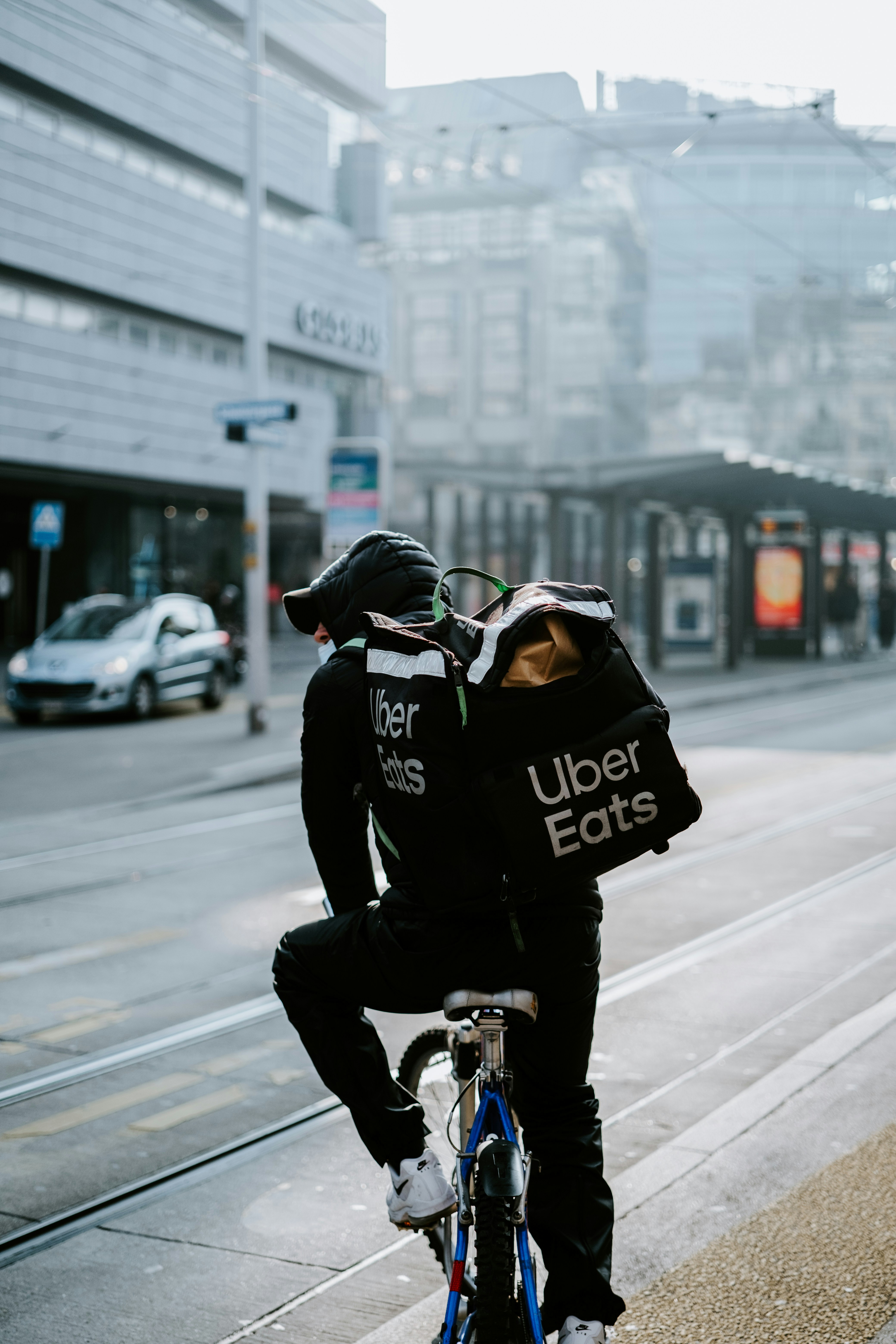 a person riding a bike on a city street